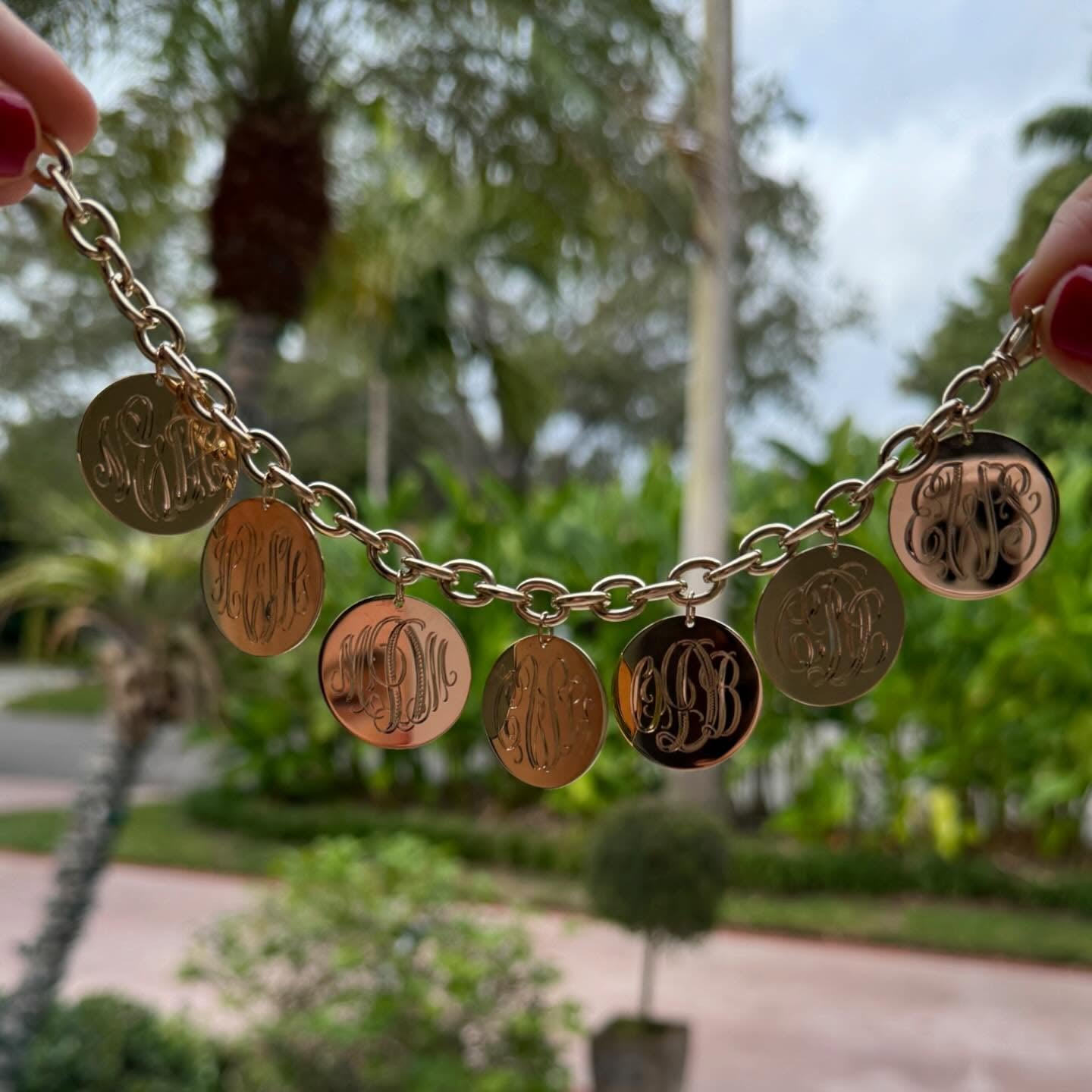 Charm bracelet with hand-engraved monogram discs