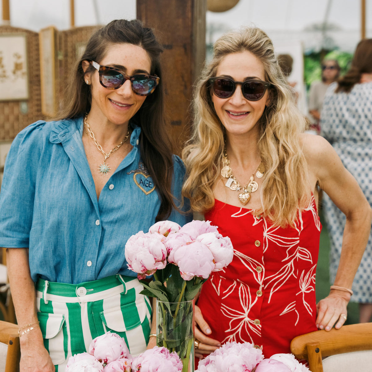 Emily and Ashley with peonies at a summer trunk show